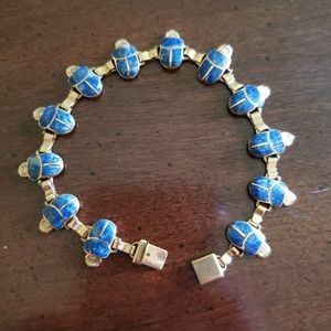 Gold bracelet with lapis scarabs